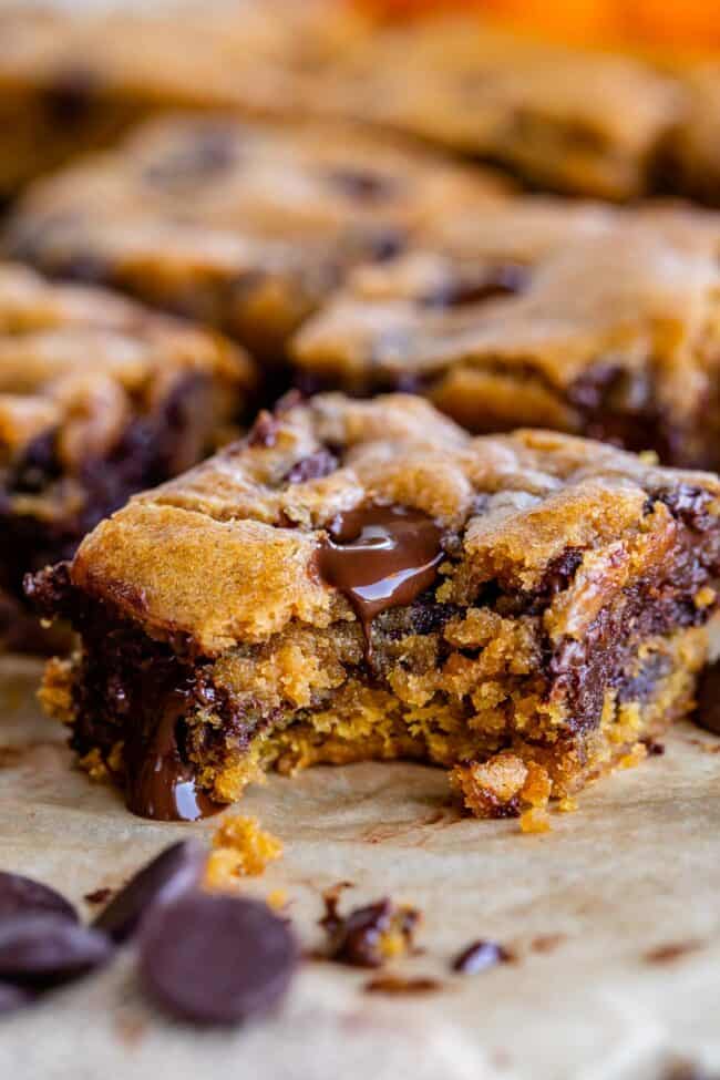 a bite taken out of the corner of a pumpkin chocolate chip bar