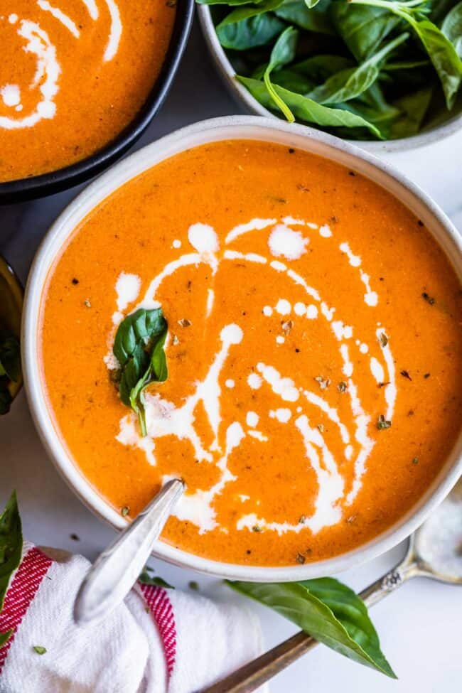 creamy tomato soup in a bowl with basil