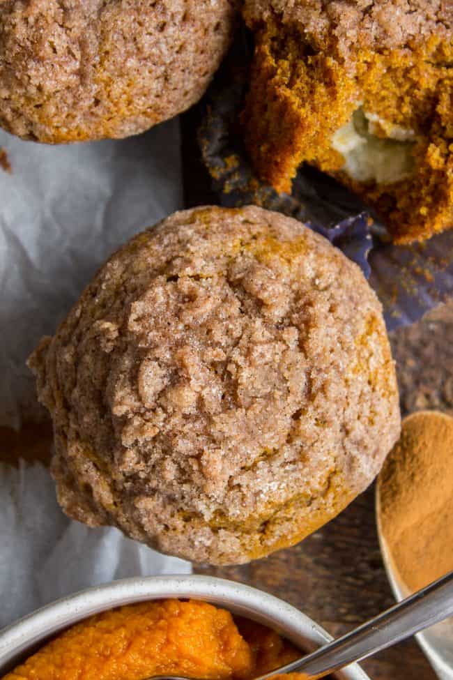 overhead of pumpkin cream cheese muffins on a counter.