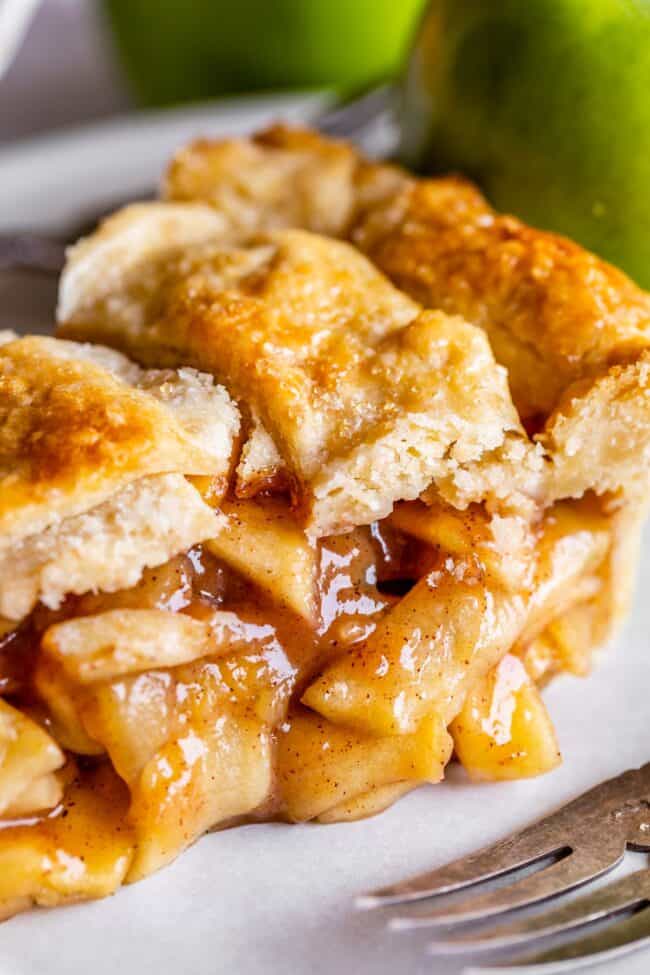 slice of homemade apple pie on a plate.