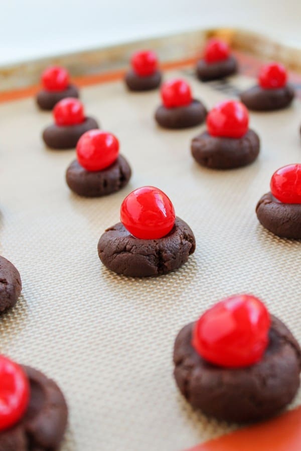 Maraschino cherry on uncooked chocolate dough