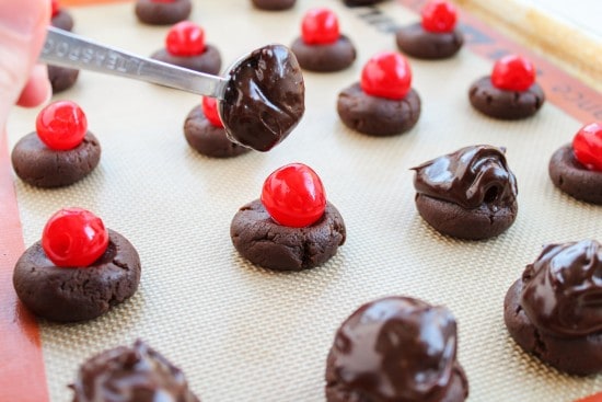 Dropping chocolate ganache on cookies