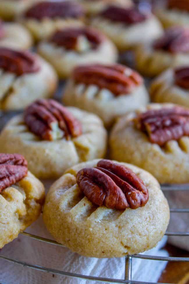butter cookies with pecans on a cooling rack.