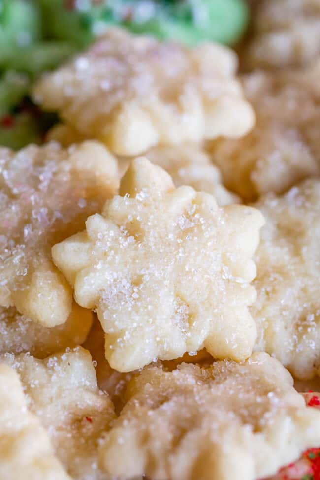 snowflake shaped buttery spritz cookies with sugary sprinkles.