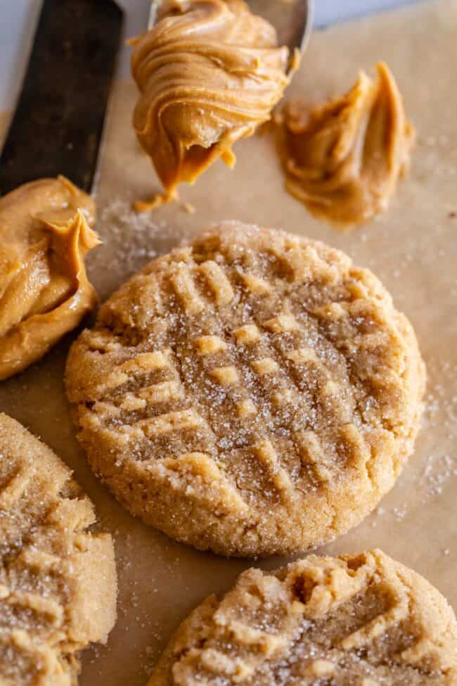 easy peanut butter cookie on a tray, with a scoop of peanut butter on the side.