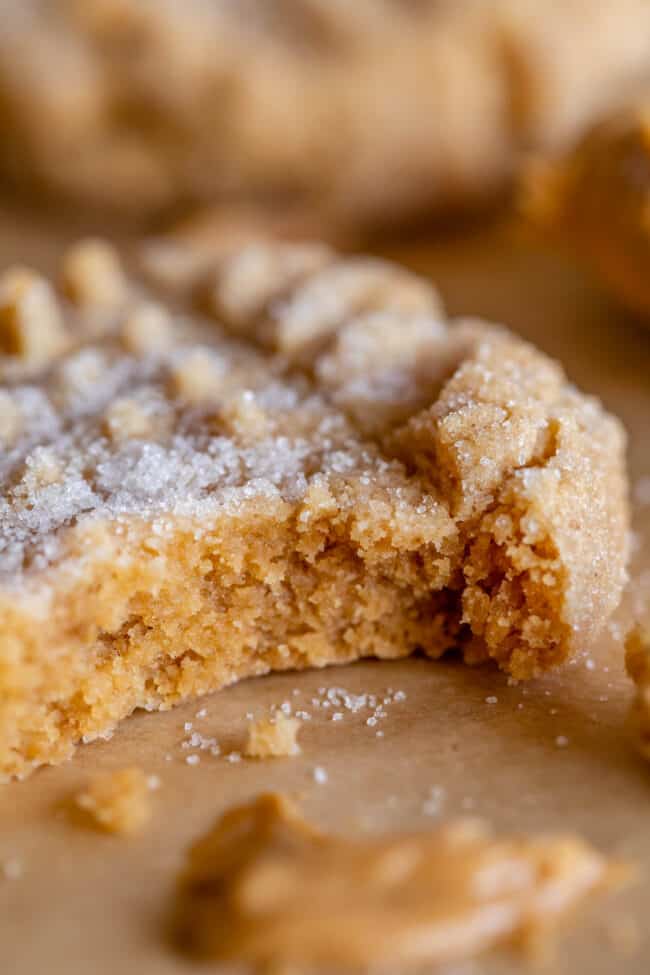chewy peanut butter cookie with a bite taken out, with sugar on top