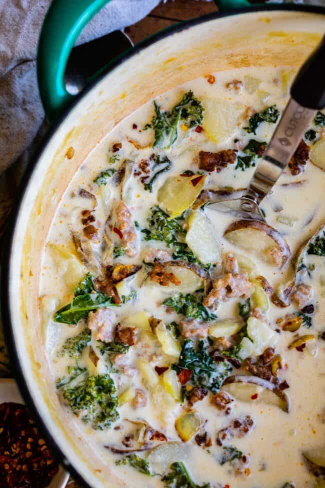 Zuppa toscana recipe in a teal pot with a serving spoon