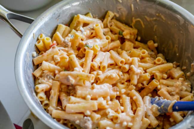 mixing ricotta mixture with cooked pasta.