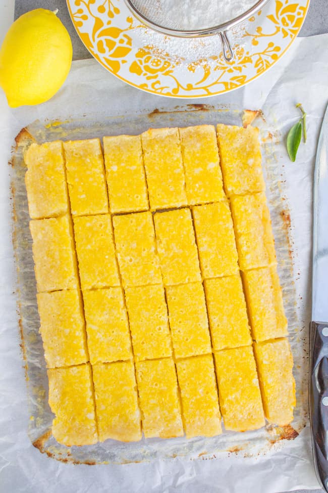 a pan of lemon bars cut into rectangular pieces.