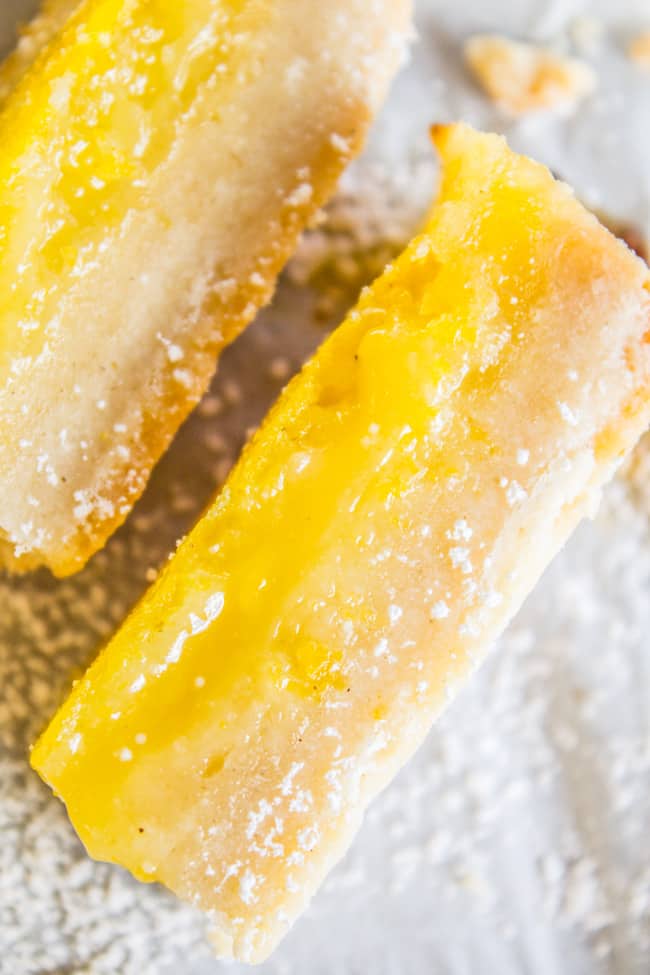 lemon squares on their sides dusted with powdered sugar.