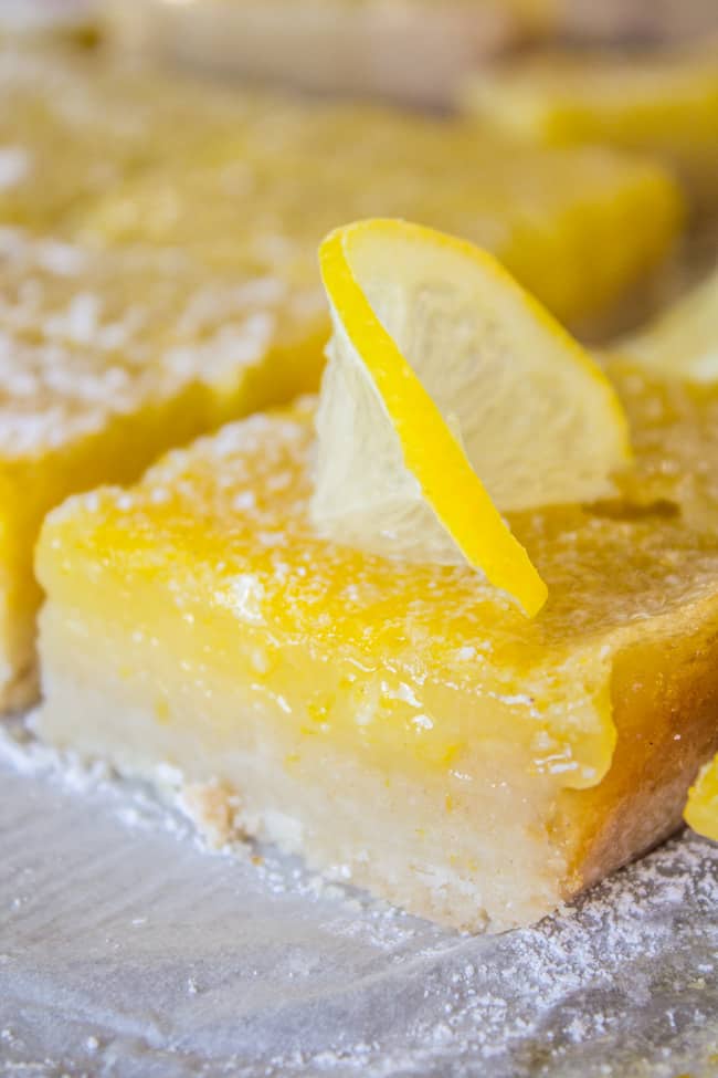 lemon squares with thick shortbread crust, dusted with powdered sugar.