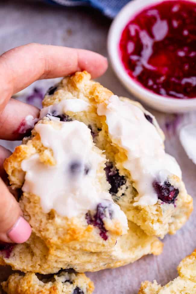 glazed blueberry scone broken to show interior.