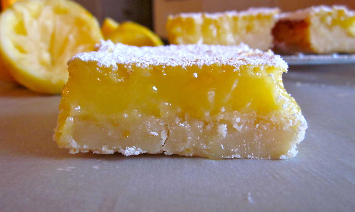 an old picture of a lemon bar with lemons in the background.