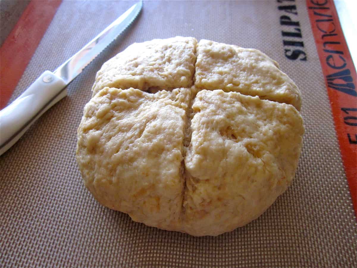 Irish soda bread with a cross-shaped score mark on top.