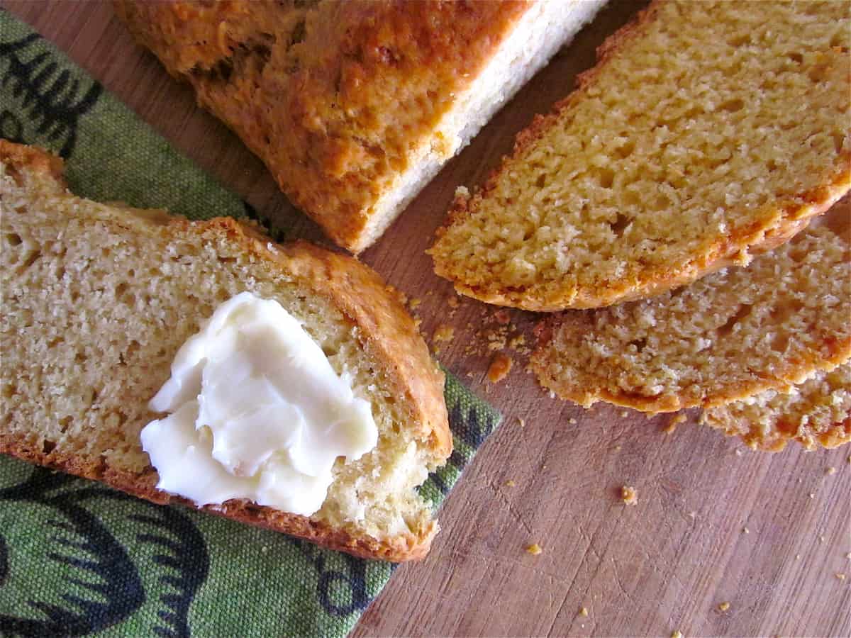 sliced Irish soda bread with butter spread on a slice.