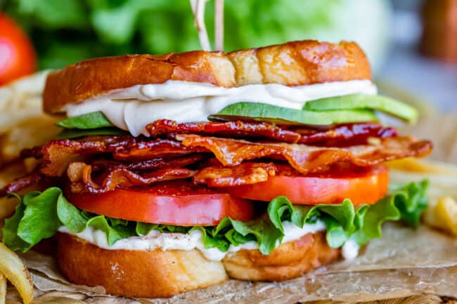 BLT sandwich with mayo, lettuce, tomato, bacon, and avocado.