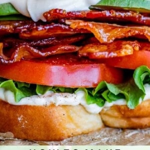 A close-up of a BLT sandwich with crispy bacon, lettuce, tomato, and mayonnaise on toasted bread. Text below reads: The Food Charlatan's BLT.