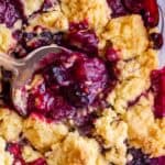 berry cobbler recipe in a pan with spoon