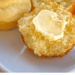 easy yeast dinner roll torn in half with a pat of butter.