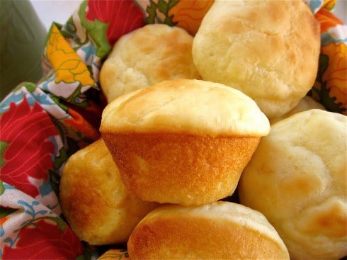 dinner rolls in a basket lined with a napkin. 