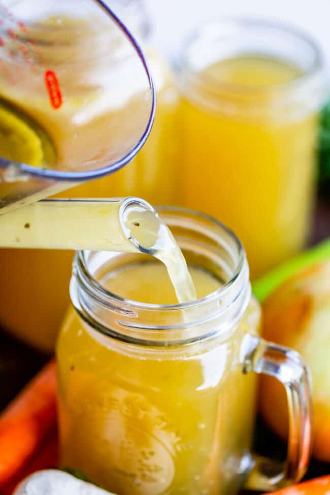 turkey stock poured from measuring cup into quart-sized Mason jar