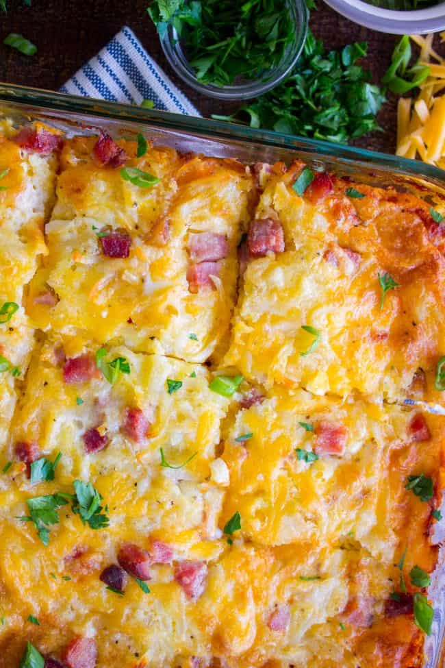 A spread of various breakfast dishes for a crowd, including breakfast casserole, pancakes, and a colorful breakfast smoothie.