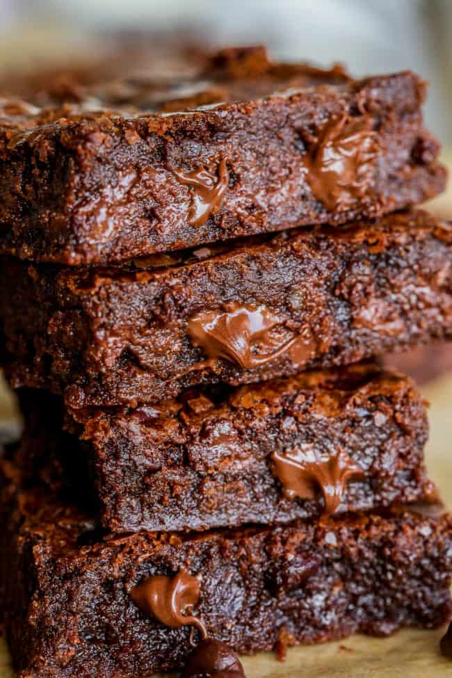 brownies in a stack with melting chocolate chips.