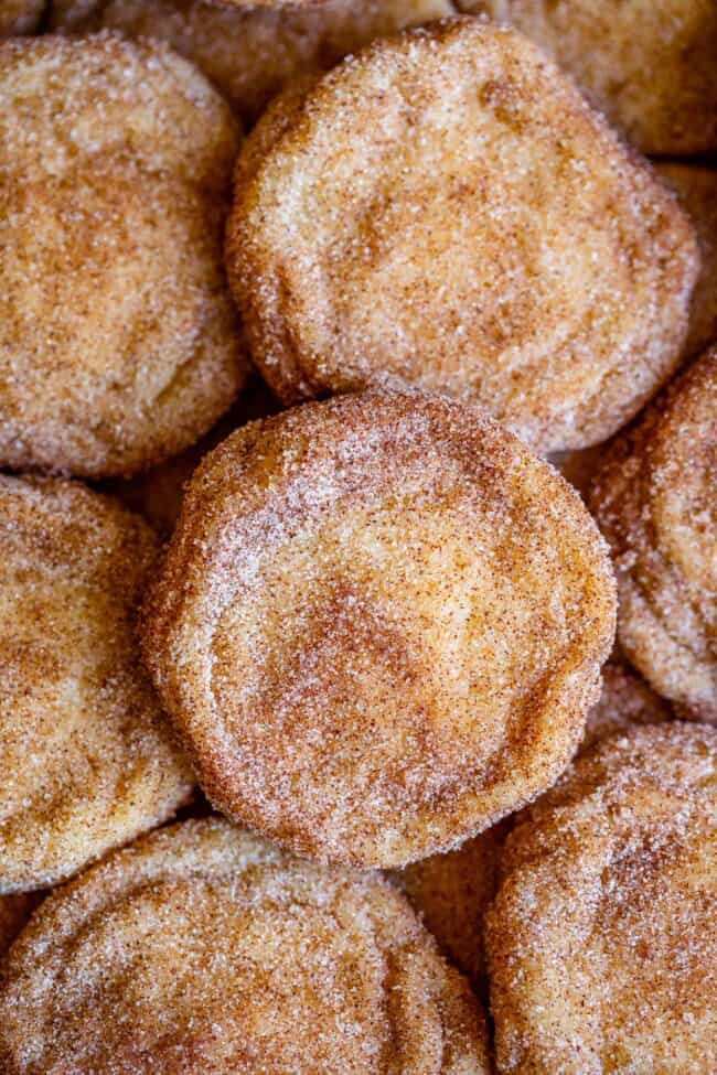 snickerdoodle cookies layered on a pan.