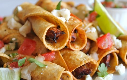 a close up shot of chicken flautas. 