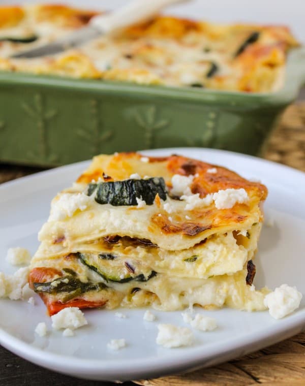 poblano, corn, and zucchini lasagna on a white plate.