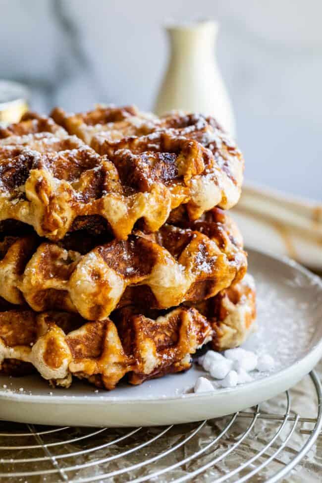 a stack of liege waffles with powdered sugar and pearl sugar. 