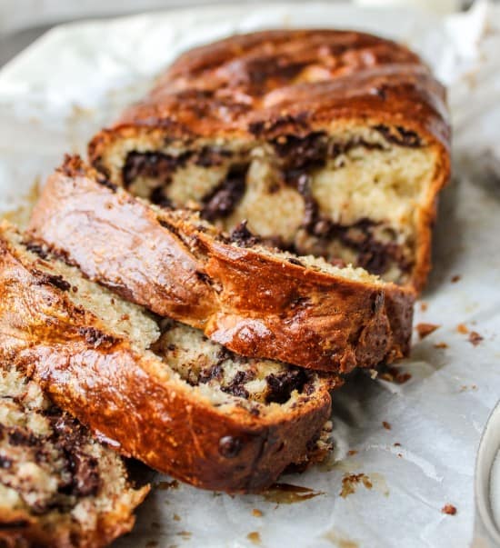 homemade chocolate babka cut in slices on parchment paper.