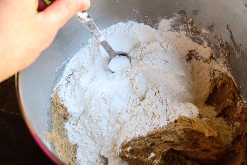 mixing dry ingredients into wet ingredients in a large bowl. 
