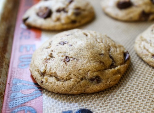 butterscotch caramel cookies cooling on a silicone mat on a cookie sheet.