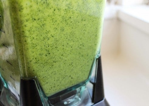 a blender full of eggs and spinach blended together.
