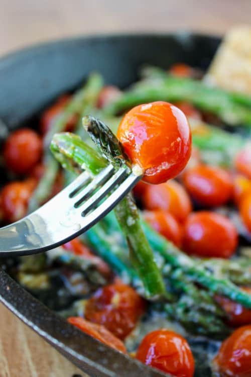 a forkful of asparagus and cherry tomatoes.