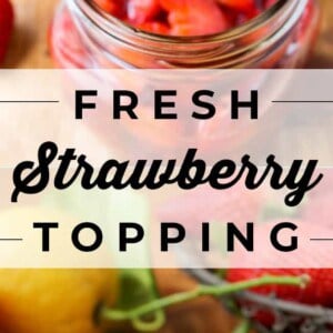 A spoon lifts sliced strawberries in syrup from a jar, surrounded by fresh strawberries and lemons. A small white bowl filled with fresh strawberry topping sits on a wooden surface. Text reads Fresh Strawberry Topping.