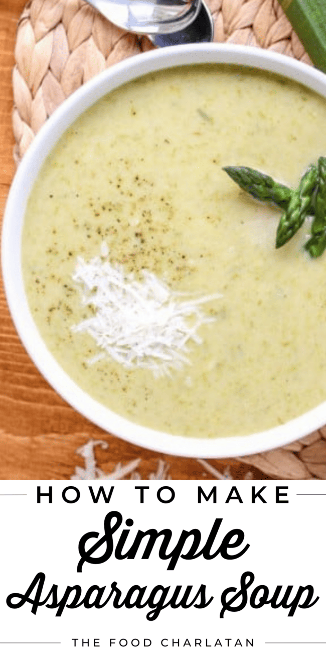 a bowl of asparagus soup with fresh basil and parmesan on top.