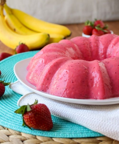 Strawberry banana jello on white plate and placemat.