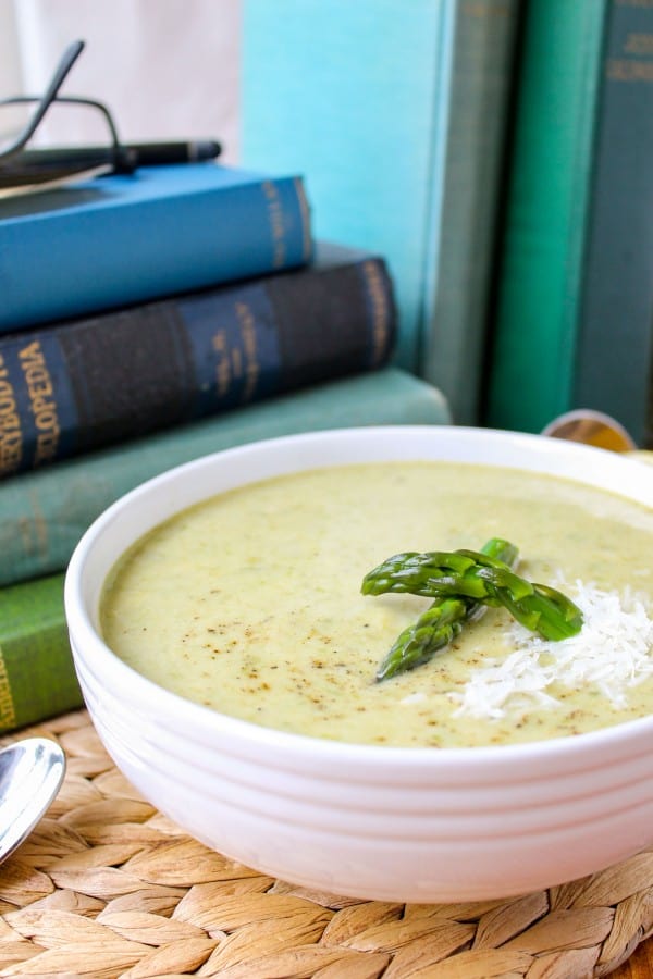 asparagus soup in a bowl with a stack of vintage books. 