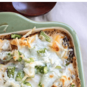 A casserole dish filled with baked tortellini casserole, topped with melted cheese and green vegetables, with text above that reads Baked Cheesy Tortellini Dinner Recipe.
