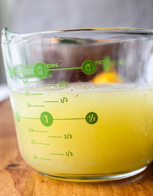 Measuring lemon juice in jar
