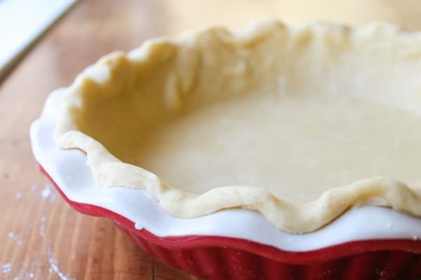 Forming the pie dough to the dish.