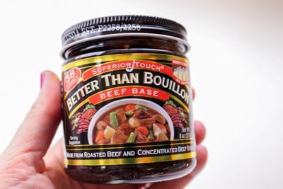 a jar of better than bouillon beef base being held.