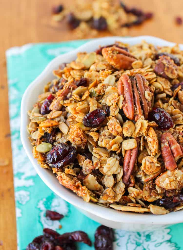 maple granola with pecans and cherries in a white bowl. 