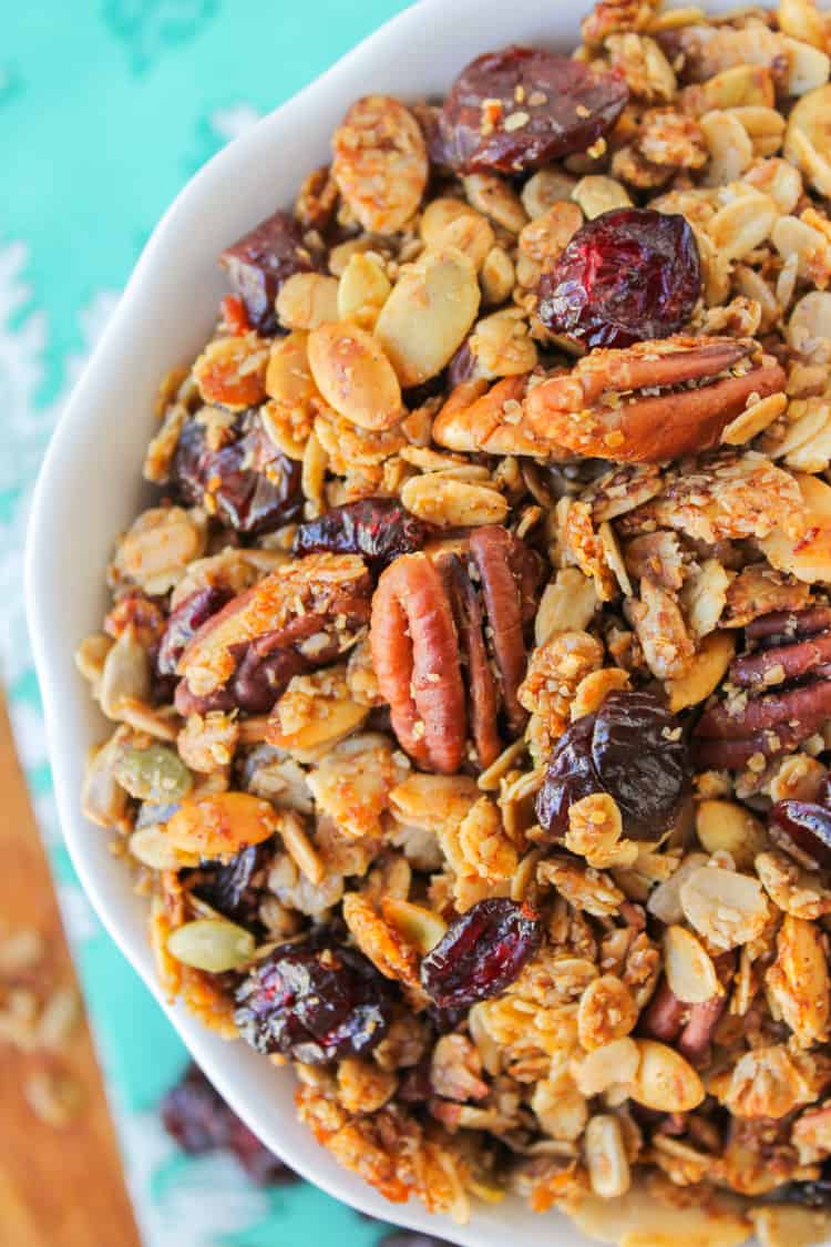 maple granola with pecans and cherries in a white bowl.