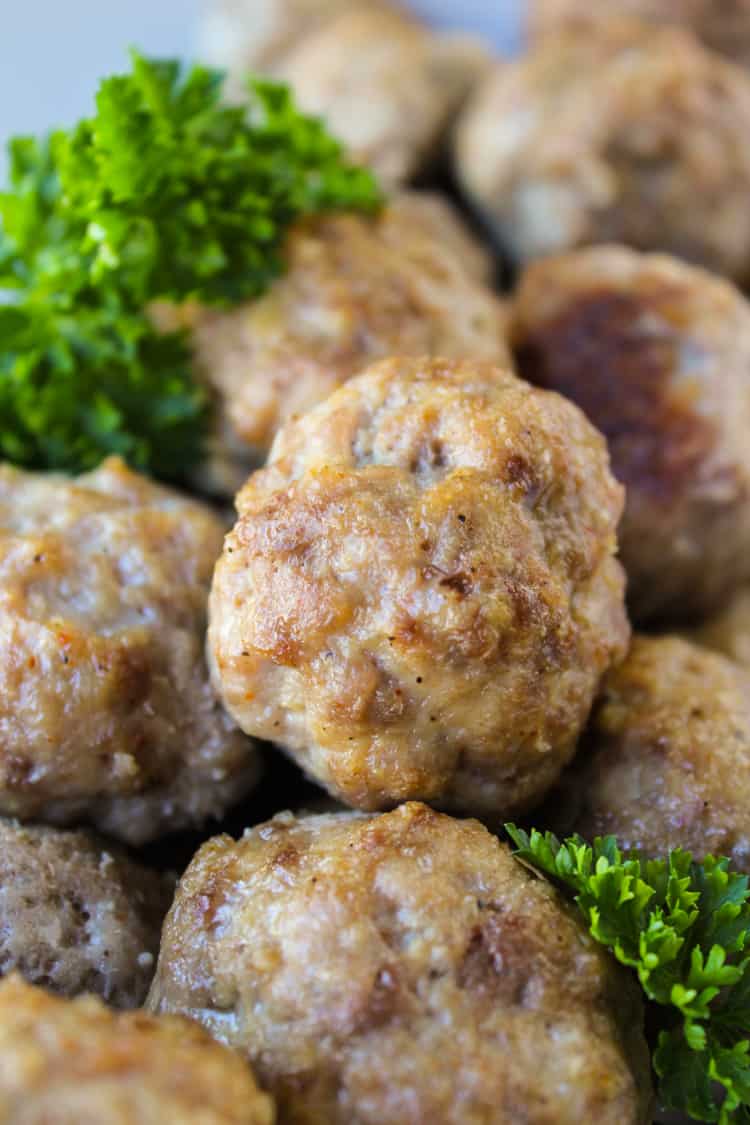 baked meatballs with parsley garnish.