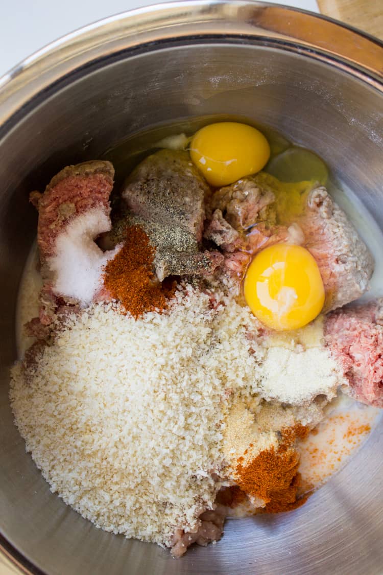 meatball ingredients in a large metal bowl.