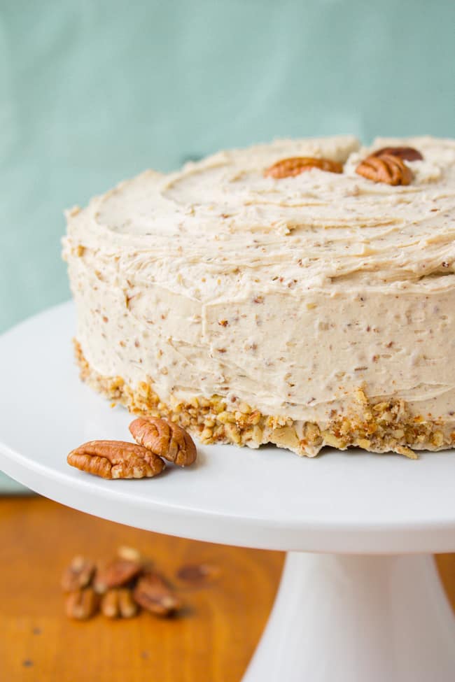 Cinnamon Cardamom Cake with Maple Pecan Frosting on cake stand