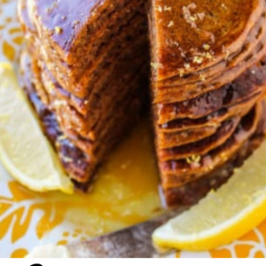 a tall stack of gingerbread pancakes with lemon syrup and butter shot from above.